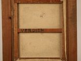 an old wooden easel with a painting on top of it