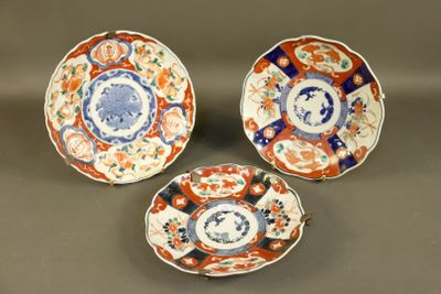 three plates with different designs on them sitting on a table