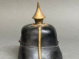 a black and gold bell on a gray surface
