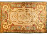 an antique rug with a floral design on a blue ground