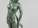 une image représentant une statue en bronze d'une femme assise par terre