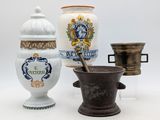three different types of vases and a mortar on a white surface