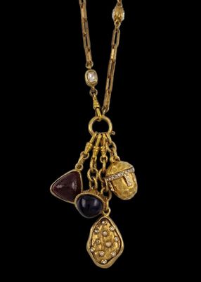 a close up of a gold plated necklace with various charms