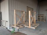 three wooden pallets that are sitting in front of a building