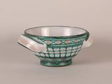 an image of a green and white bowl sitting on a table