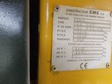 a metal sign on the side of a yellow machine
