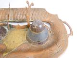 a metal object that is sitting on top of a plate