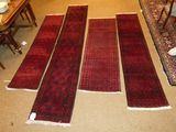 several rugs laid out on the floor in a living room