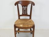 an image of a wooden chair with a wicker seat and back