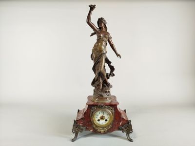 a statue of a woman holding a clock on a table