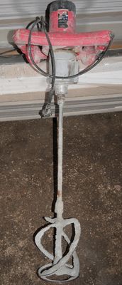 an image of a red and white drill on a wall