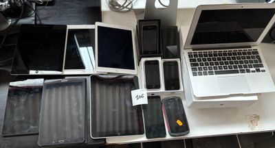 several laptops, phones, and tablets are sitting on a table