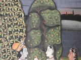 a painting on the wall of a building with a painting of a man and a woman