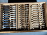 a wooden box with a bunch of knives inside of it