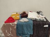 a pile of clothes sitting on top of a wooden box