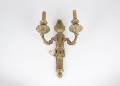 pair of antique brass wall sconces on a white background