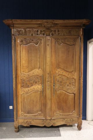 Importante armoire en chêne sculpté et mouluré de paniers fleuris...