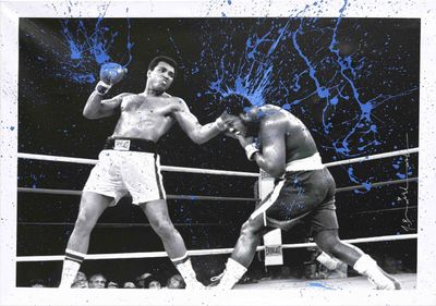 photograph of two boxers fighting in a boxing ring with blue splats