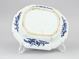 a small blue and white bowl with a gold rim