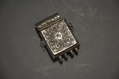 a close up of a small metal object on a table