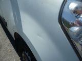 a reflection of a man in the side mirror of a car