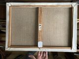 a person holding up a picture frame with a picture on it