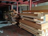 many pieces of wood stacked on top of each other in a warehouse