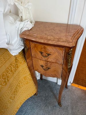 a small wooden table with a drawer on top of it