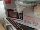 boxes of microwaves stacked on top of each other on a shelf