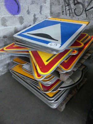 a stack of street signs that are stacked on top of each other