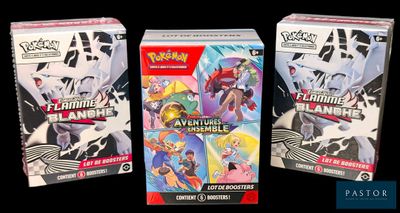 two boxes of pokemon trading cards are sitting next to each other