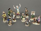 many figurines of people that are standing together
