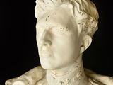 marble bust of a man in a military uniform on a black background