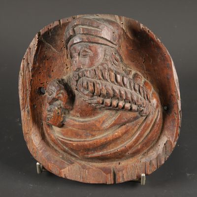 a close up of a wooden sculpture of a man with a beard