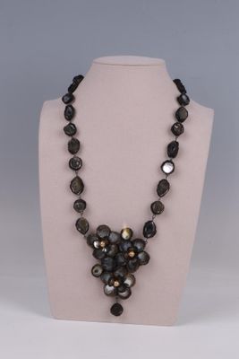 Le collier est composé de perles de verre et d'une perle noire