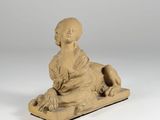 an image of a statue of a woman sitting on a wooden block