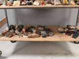 a wooden shelf with rocks and other rocks on it