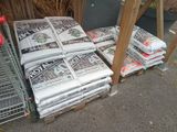 many newspapers stacked on top of each other on the street