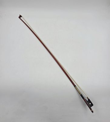 a close up of a violin bow on a white surface
