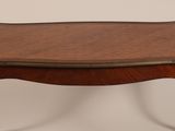 an old wooden table with a leather top on a white background