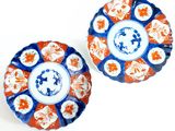 pair of blue and orange plates with floral designs on them