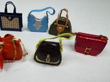 several small purses are lined up on a white surface