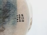 a close up of a vase on a table