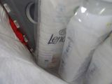 a bag full of toilet paper and a bottle of lotion