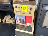 a box of wood next to a stack of stoves