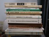 many books stacked on top of each other on a table