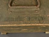 an old suitcase that has a handle on it