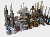 many different types of candles and vases on the table