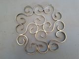 a lot of silver rings arranged in a circle on a table