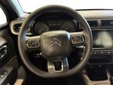 the interior of a car with a steering wheel and dashboard controls